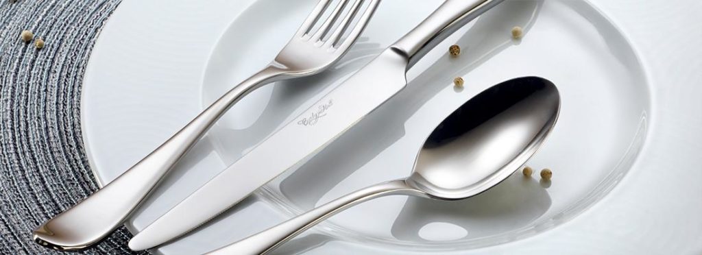 stainless steel flatware and porcelain dessert plate